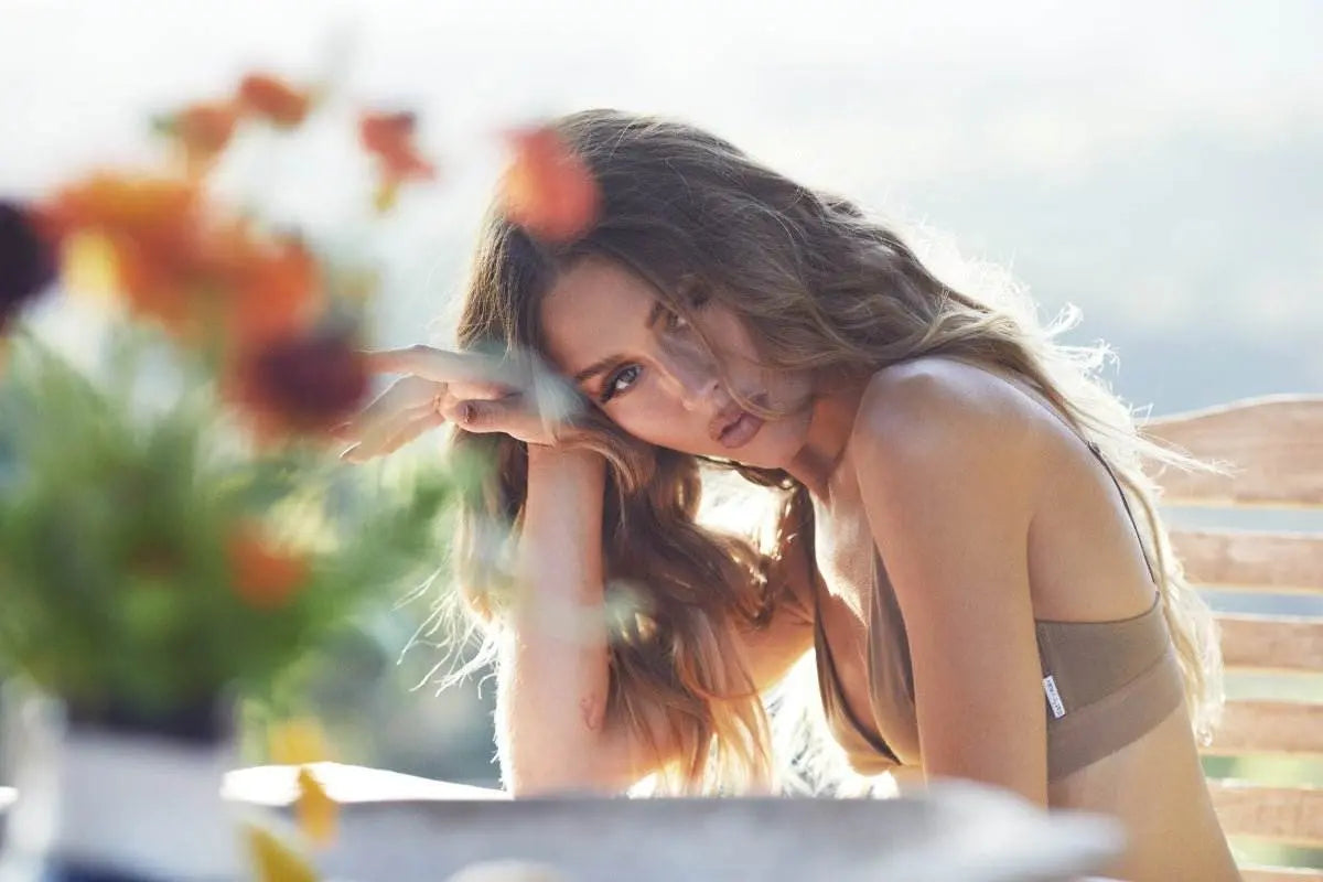 Woman in brown eco-friendly nativ basics x Ruby Tuesday Matthews bra relaxing outdoors with soft sunlight in Byron Bay Hinterland.