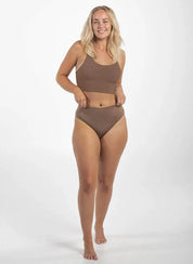 Woman wearing brown high-waisted seamless G string shapewear underwear and matching crop top