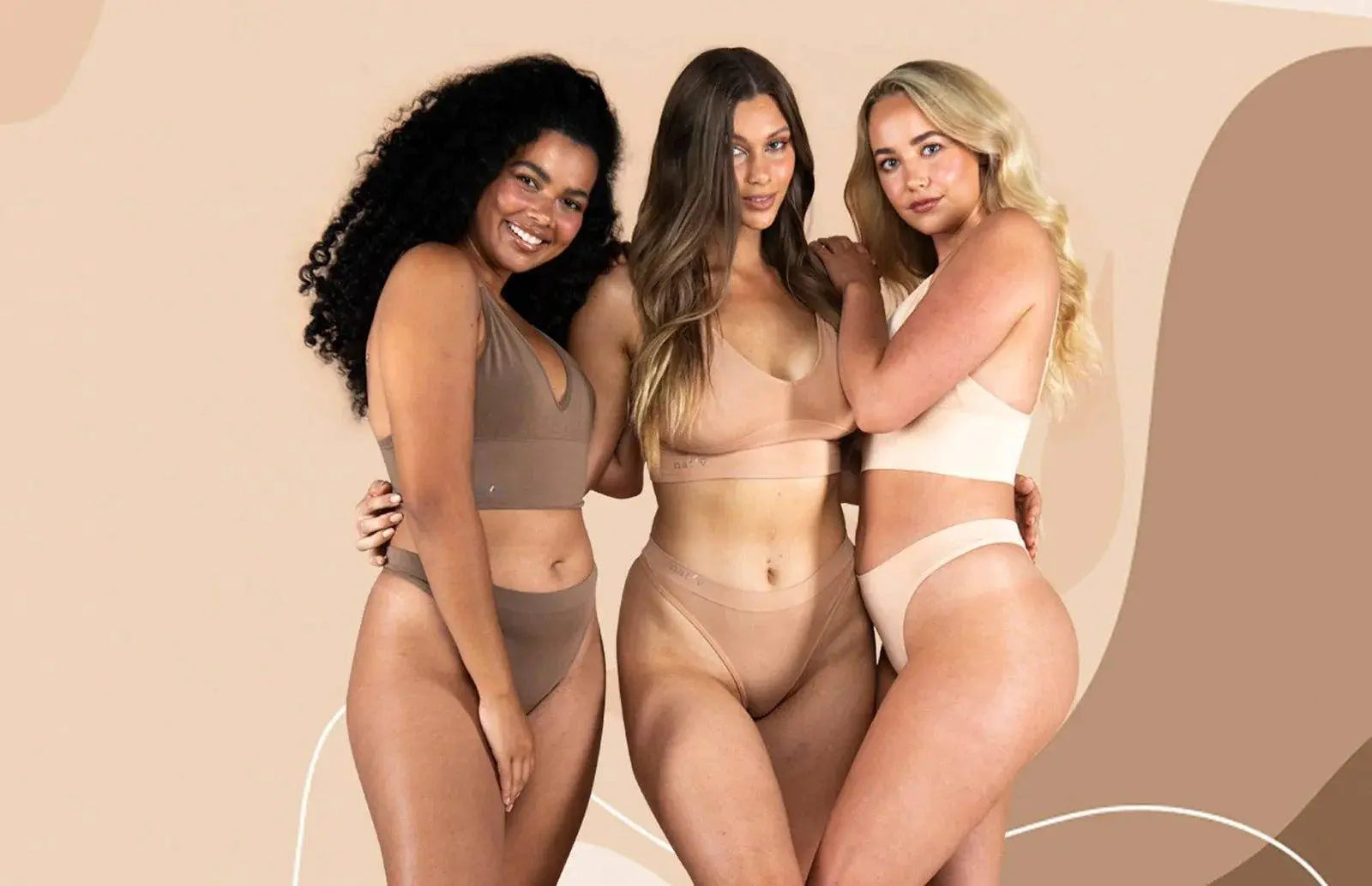 Three diverse women wearing neutral-toned bralettes and matching underwear, showcasing the comfort and style benefits of choosing a bralette over a traditional bra.