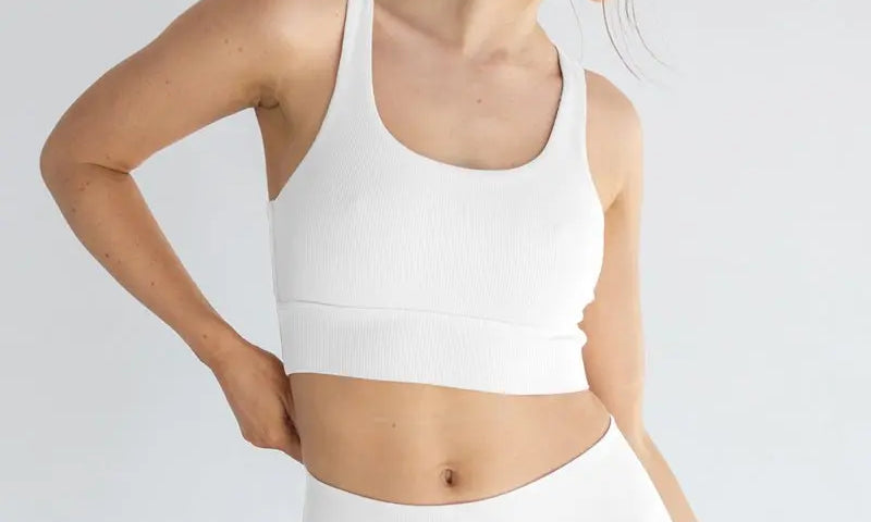 Woman wearing white seamless underwear set demonstrating comfort and sustainability benefits of seamless manufacturing for reducing textile waste