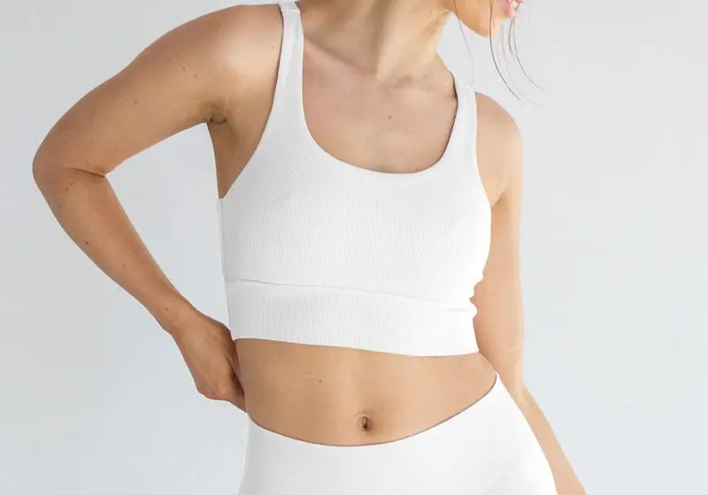 Woman wearing white seamless underwear set demonstrating comfort and sustainability benefits of seamless manufacturing for reducing textile waste
