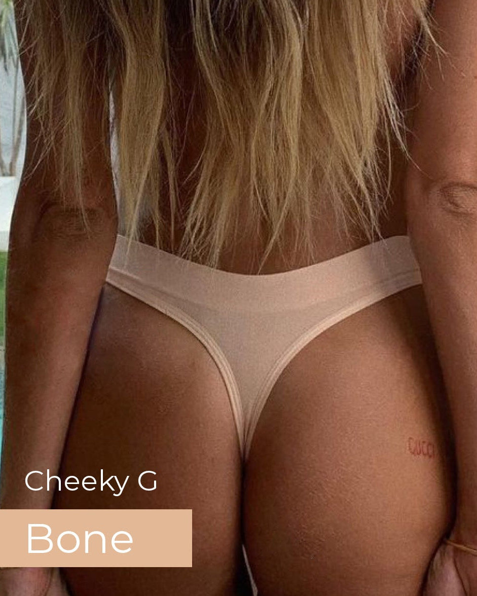 Person wearing a beige thong with 'Cheeky G Bone' text, standing by a poolside.