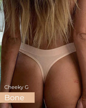 Person wearing a beige thong with 'Cheeky G Bone' text, standing by a poolside.