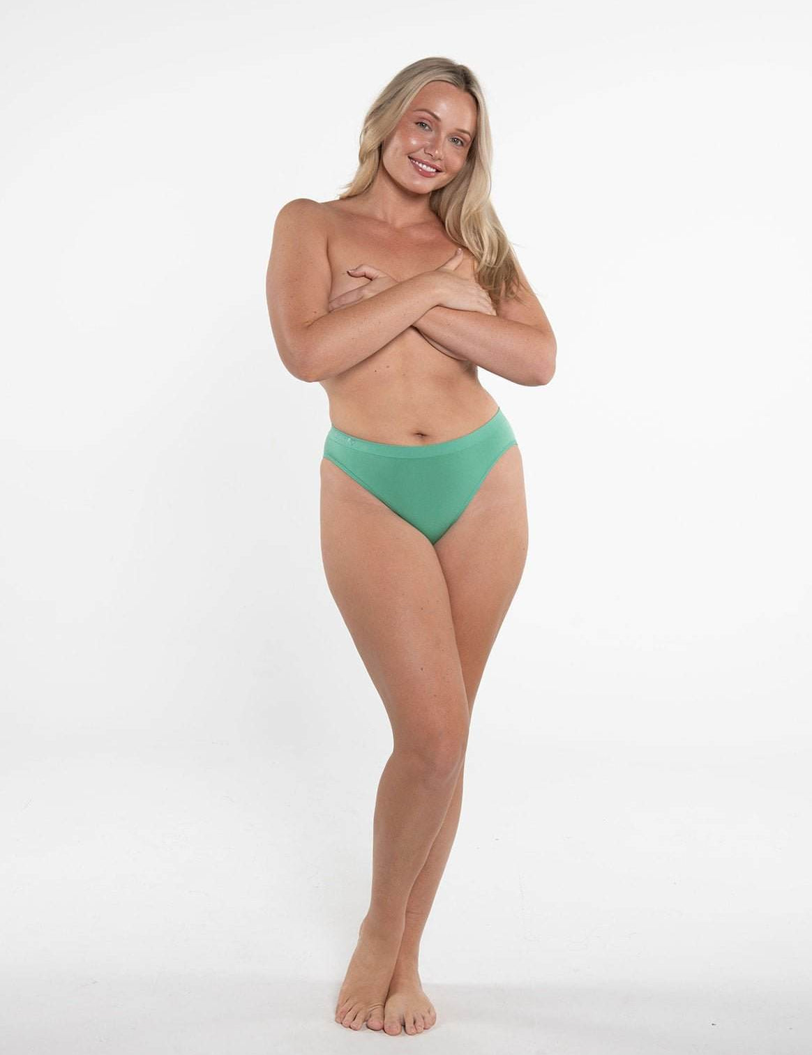 Smiling woman wearing green Callie Brief natural hip bikini underwear from underwear bundles set