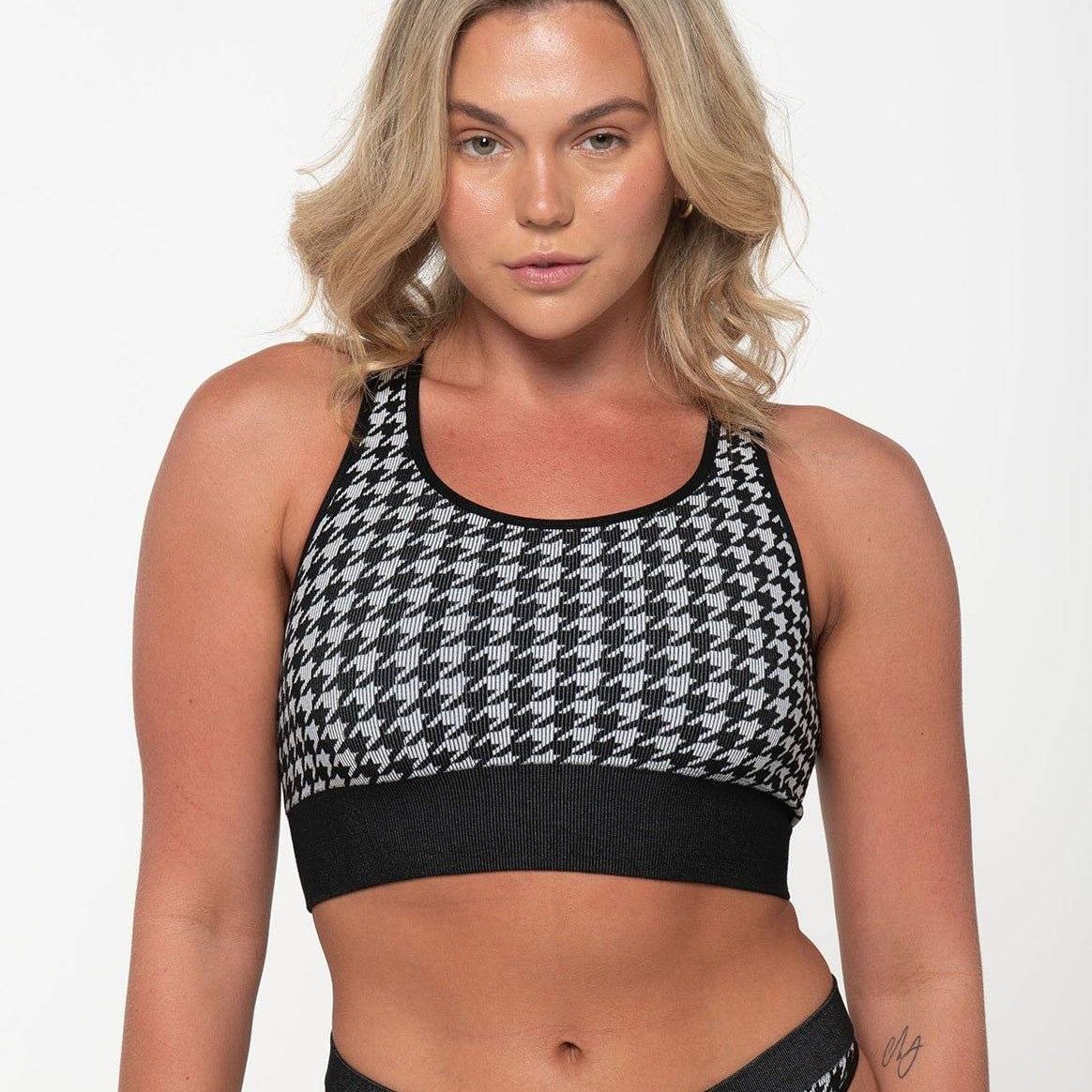 woman wearing black and white houndstooth racerback tank top and matching underwear set