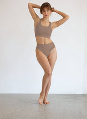 Woman wearing high-waisted ChiChi G shape-shifting G string in chestnut color with firm waistband and tummy control.